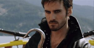 Brooding pirate holding curved metal hook