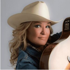 Woman in cowboy hat with guitar.