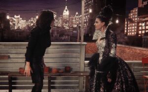 Two women arguing on a rooftop.