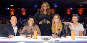 Panel of judges with one standing behind them