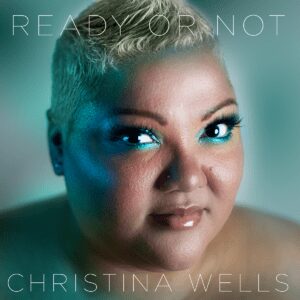 Portrait of Christina Wells with colorful makeup.