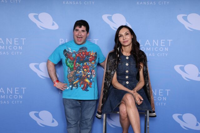 Actress Famke Janssen poses with Jake's Take with Jacob Elyachar host Jacob Elyachar at 2026 Planet Comicon Kansas City